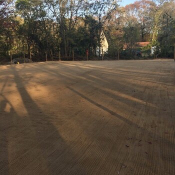 Empty lot that has been flattened to provide a riding surface for horses